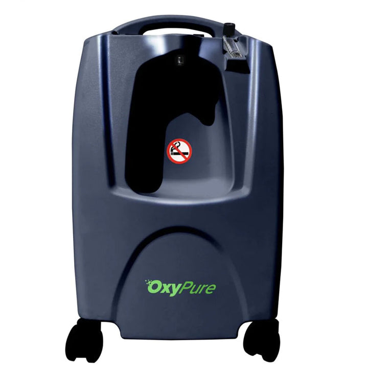 Dark blue Oxypure oxygen concentrator with handle, flowmeter, no smoking sign, and caster wheels.