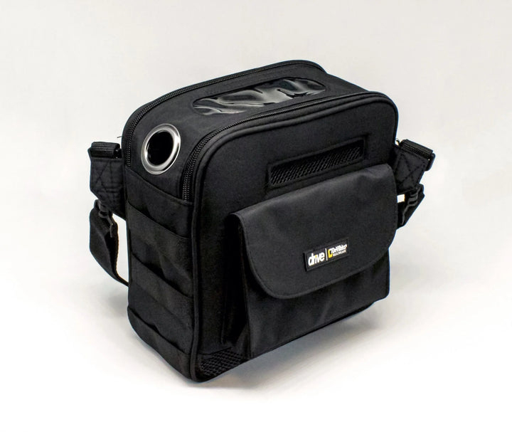Black rectangular carrying case with front pocket, shoulder strap, clear top window, and metal ventilation ring.