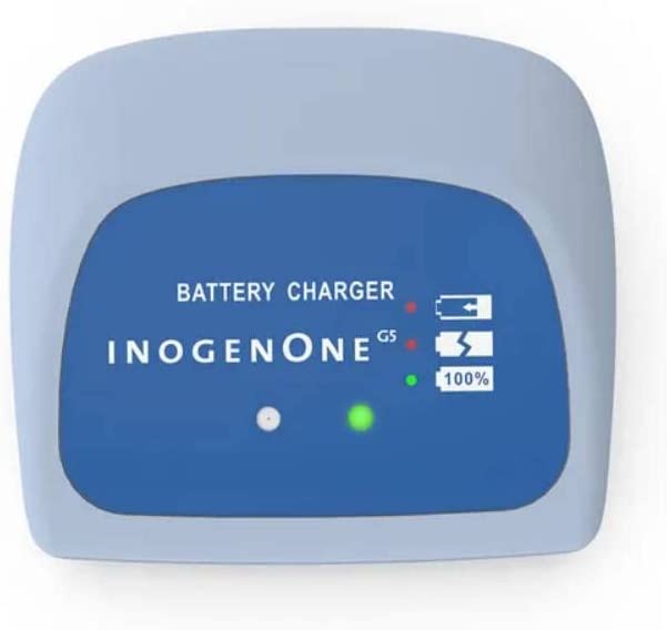 Compact external battery charger with blue front panel, indicator lights, and Inogen One G5 branding.