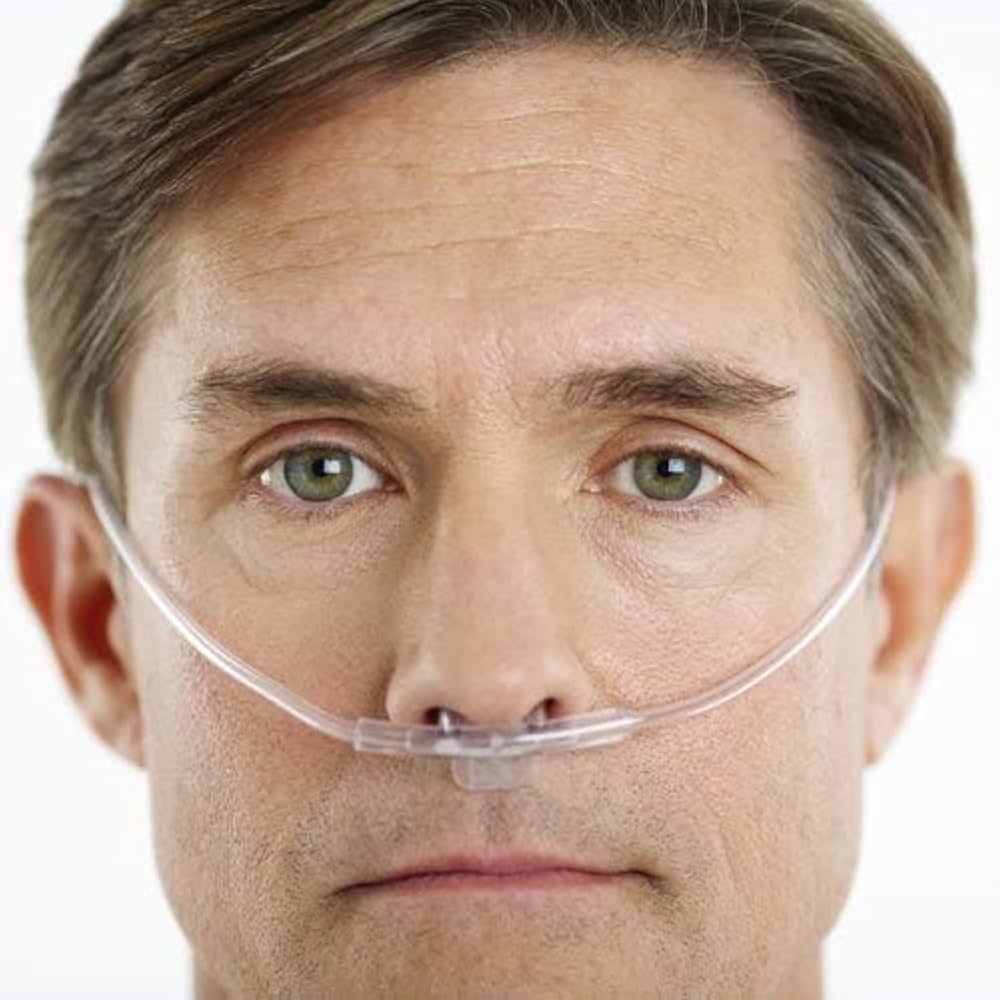 Clear nasal cannula positioned under the nose with soft, flexible tubing around the ears.