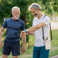 Older man outdoors wearing a portable oxygen concentrator bag with nasal cannula and checking his smartwatch.