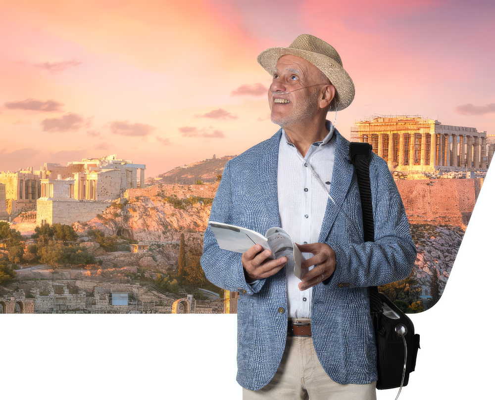 Older man wearing a hat and nasal oxygen cannula with a black shoulder bag and guidebook, ancient ruins in background.